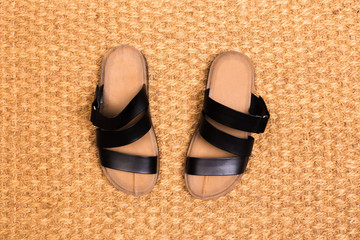 Cleaning foot carpet with sandals welcome home