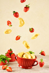 Levitating food. Pierogi. Dumplings with with strawberry are flying. Ready meal.