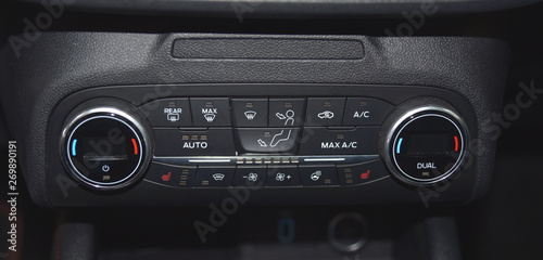 buttons for activating the air conditioners on the dashboard passenger car
