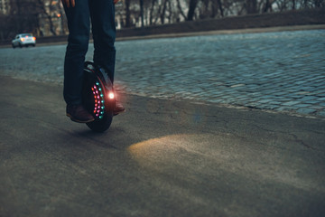 monowheel or electric unicycle in use on night street © Oleksandr
