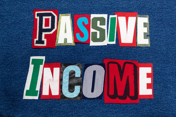 PASSIVE INCOME text word collage colorful fabric on blue denim, side gig, horizontal aspect