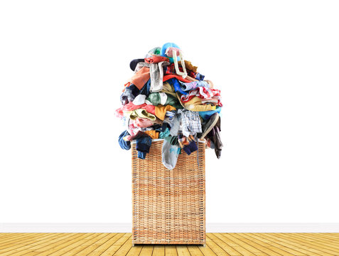Beige straw basket full of dirty Laundry
