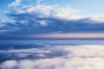 Naklejka na ściany i meble above the clouds cloudscape. cloudy weather in the mountains. blue sky aerial view background.