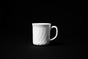 Realistic white cup isolated on dark background.  White ceramic cup with saucer. Cup of tea.