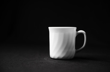 Realistic white cup isolated on dark background.  White ceramic cup with saucer. Cup of tea.