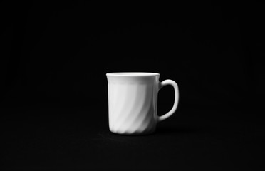 Realistic white cup isolated on dark background.  White ceramic cup with saucer. Cup of tea.