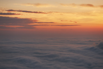 Fototapeta na wymiar beautiful sunset above the clouds in the mountains. stunned landscape background with copy space. aerial mountain view