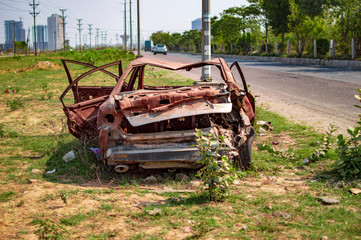 Burned car with burnt paint on the road side