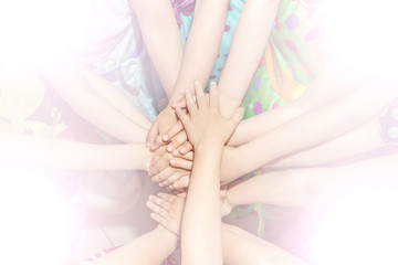 Naklejka premium Group of children putting their hands together. Concept teamwork partnership