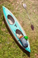 inflatable whitewater kayak with a paddle on green grass shore pack with hermetic bag