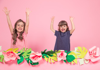 Obraz na płótnie Canvas two little girls on summer pink background