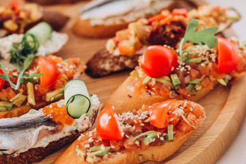 sandwich with trout, cherry tomatoes and lettuce. a plate of snacks.
