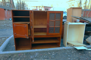 Old furniture on the street thrown into the garbage while cleaning the house.