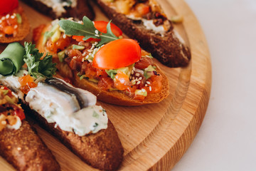 sandwich with trout, cherry tomatoes and lettuce. a plate of snacks.