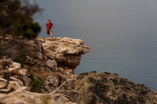 Man standing on the rock near the sea water