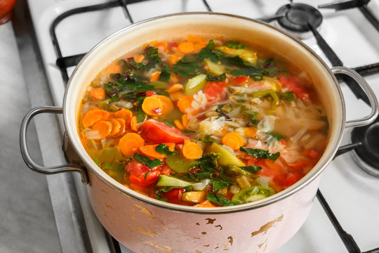 Pan Of Vegetable Soup On Gas Stove. View From Above