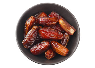 date fruit in a black plate isolated on white background. top view