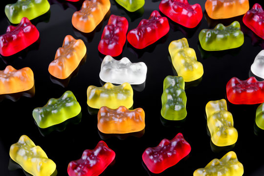 Jelly bears on a black background. Multicolored sweets on a black background.
