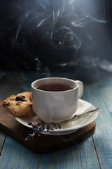White cup of tea with water stream cookies handmade close up gray