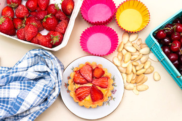 strawberry tart, almond and cherry in basket 
