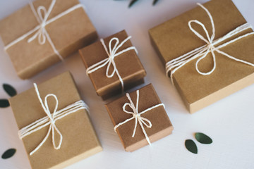 Craft gift boxes on white wooden background.