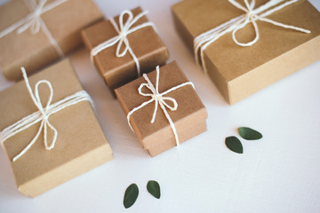Craft gift boxes on white wooden background.