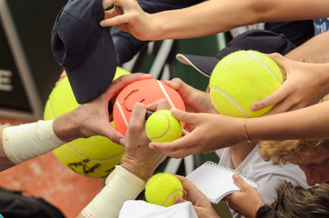 Tennis player signs autograph after win