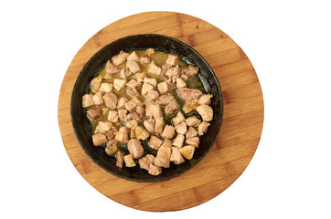 Meat cooked in a frying pan diced on a wooden Board isolated on white
