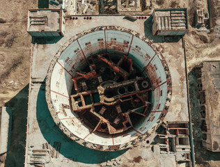 Aerial top down view of ruined Nuclear Power Plant in Crimea. Industrial construction with round...