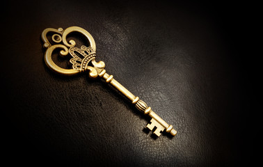 Old bronze key on a dark background
