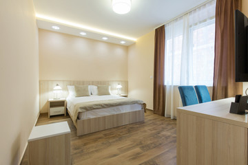 Fototapeta na wymiar Hotel room interior, beige bedroom