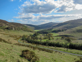 Naklejka premium Landscape of Ireland with road, mountains and clouds. Nature Reserve.