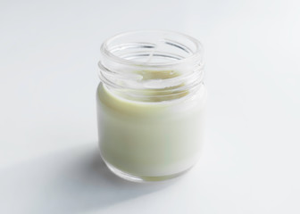 Obraz na płótnie Canvas glass jar with cosmetic cream on a light background. copy space