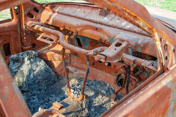 Burned car with burnt dash and wheel