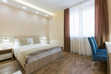 Hotel room interior,double bed beige bedroom