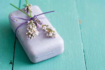 lavender soap and flowers on worn blue painted wooden table background