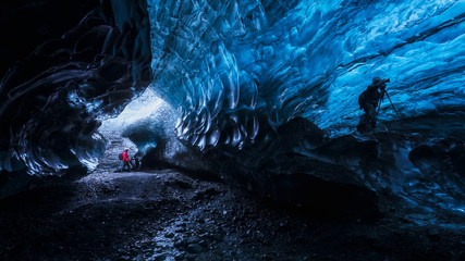 Photographer inside a blue ice cave in Iceland