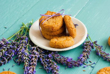 stack of lavender cookies on enamel plate, aged blue wooden table