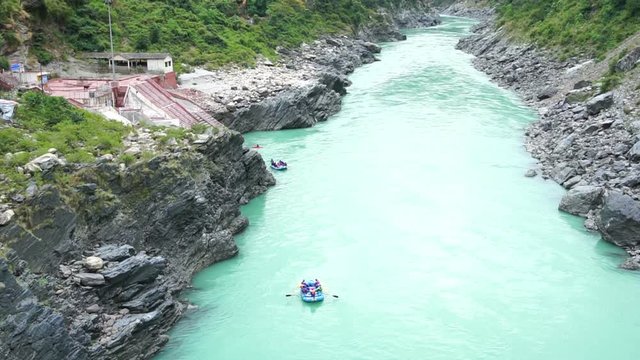 River rafting on Holy river Ganges near Rishikesh, also known as Hrishikesh, Uttarakhand, India. River rafting is a adventure sport conducted on the river Ganges - a famous tourist attraction.