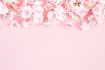 Fototapeta na wymiar Flowers composition. Hydrangea flowers on pastel pink background. Flat lay, top view, copy space