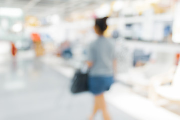 Blurred bix box store supercenter with customers shopping for home goods.