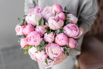 Pink peonies in womans hands. Beautiful peony flower for catalog or online store. Floral shop concept . Beautiful fresh cut bouquet. Flowers delivery - obrazy, fototapety, plakaty