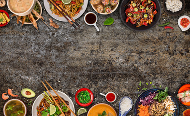 Asian food background with various ingredients on rustic stone background , top view. Vietnam and Thai cuisine.