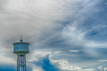 Water tank tower at evening on cloud background