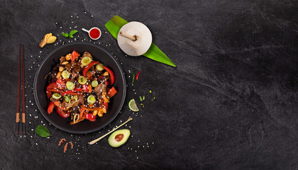 Szechuan beef asian food background with various ingredients on rustic stone background , top view. Vietnam or Thai cuisine.