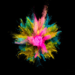 Colored powder explosion on black background. Freeze motion.