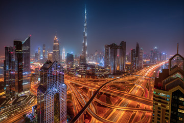 Fototapeta na wymiar Dubai skyline during sunrise with shining traffic road, United Arab Emirates.