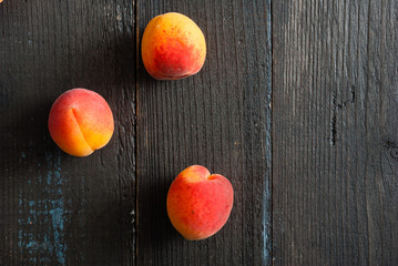 peaches on black wood table