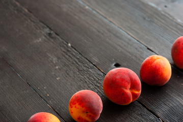 peaches on black wood table