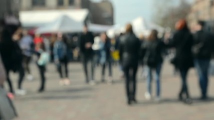 People walk around the square
